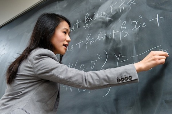 Professor Liu writing on chalkboard