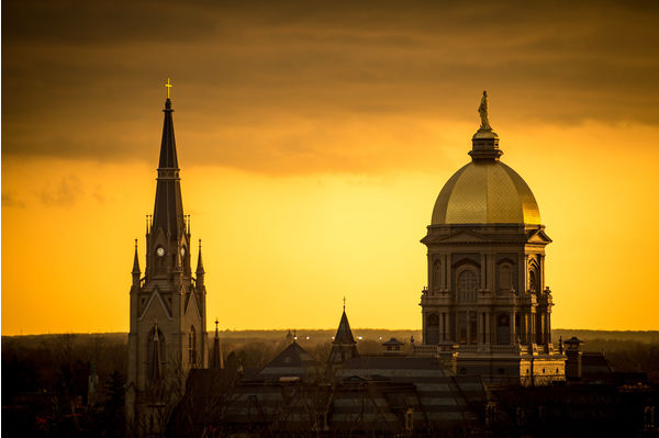 Main building and basilica in front of golden sky
